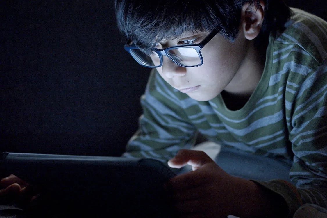Screen light reflects on eyeglass lenses while reading a digital display