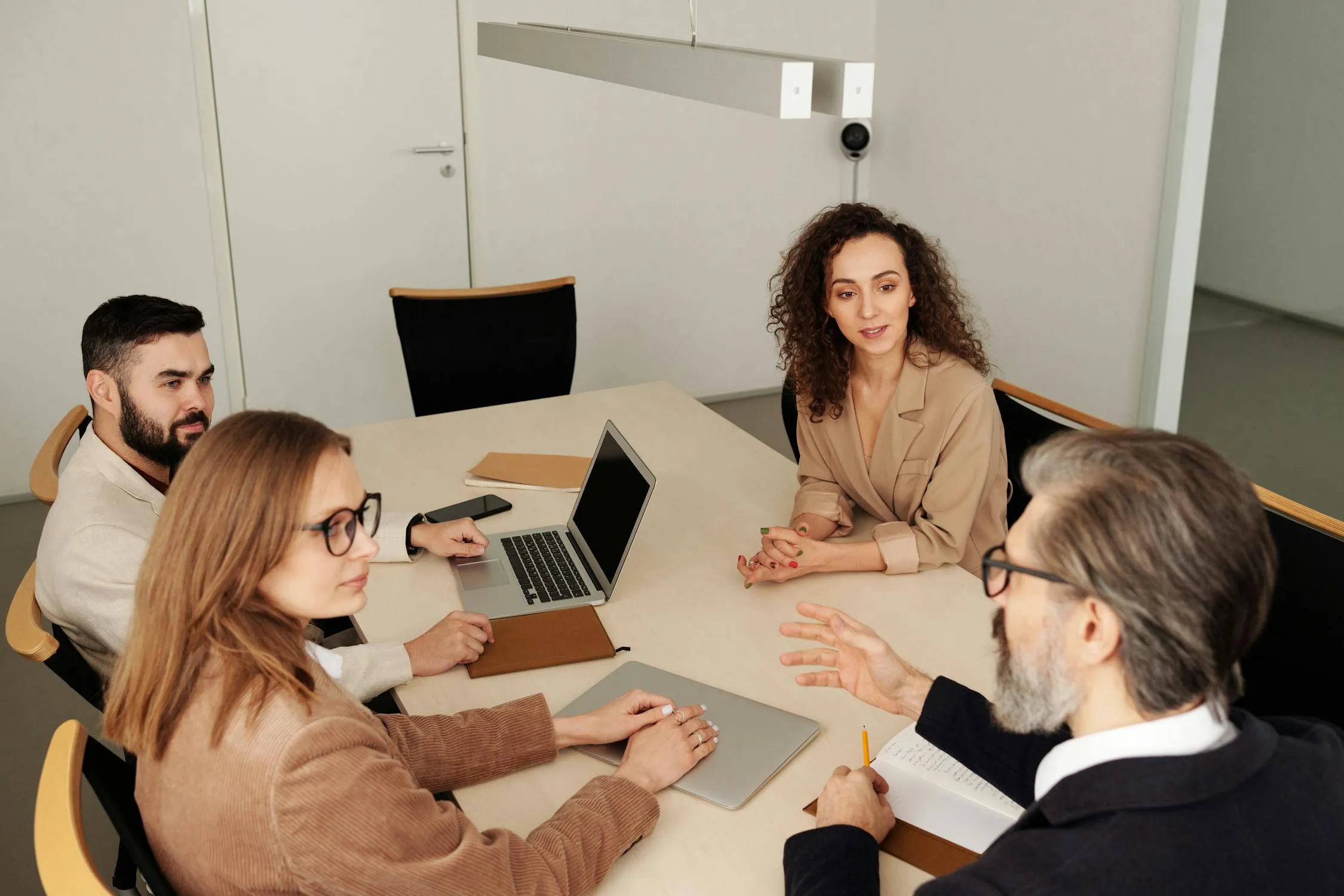 Professional team in discussion at a modern office conference table
